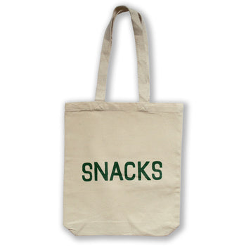 canvas tote bag printed with the word snacks in all caps