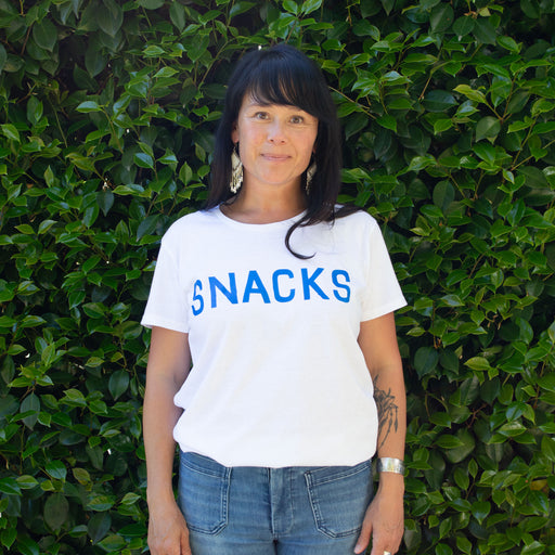 Basic white t-shirt screenprinted with "Snacks"