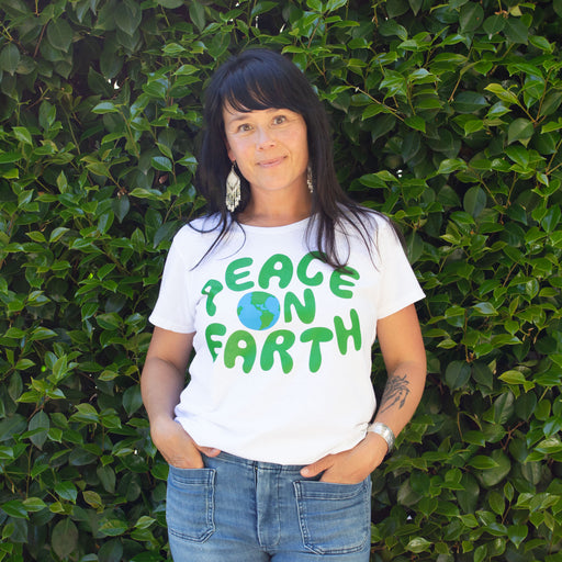 happiest peace on earth t-shirt, graphic blue lettering with the earth on a simple and classic white t-shirt