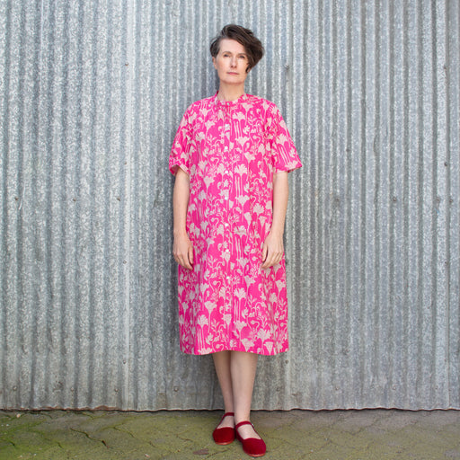 collarless, below the knee shirt dress with shell buttons and printed with deep pink california poppies